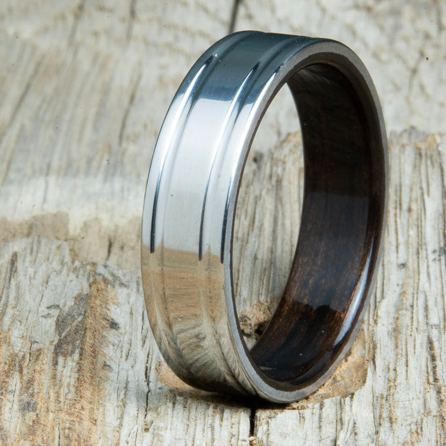 Ebony bentwood ring with polished double groove 6mm titanium. Custom bentwood wedding bands made by Peacefield Titanium