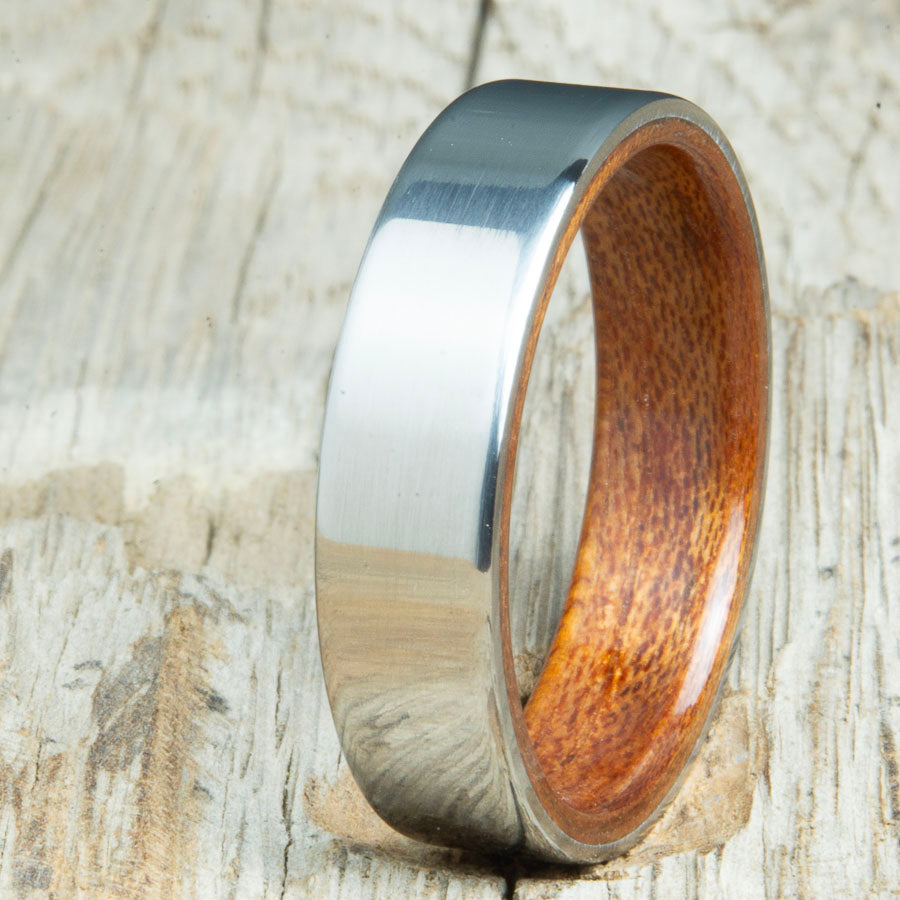 Classic mens Acacia wood wedding band with polished titanium. Custom wood rings made by Peacefield Titanium