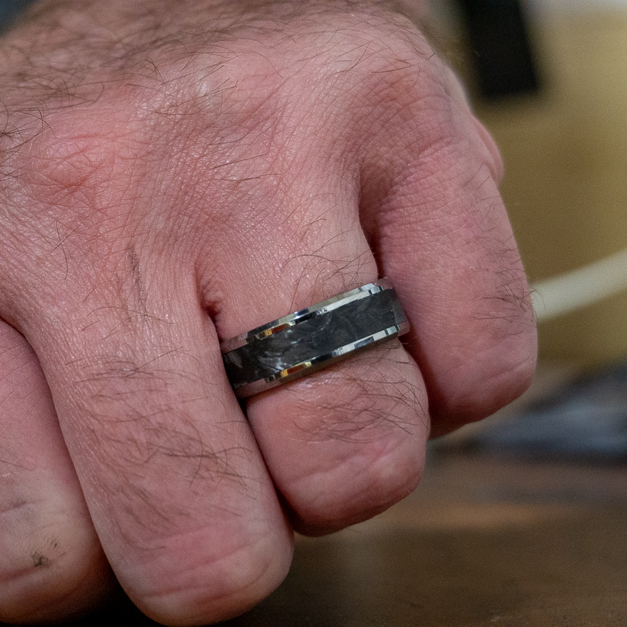 tungsten forged carbon fiber ring on finger