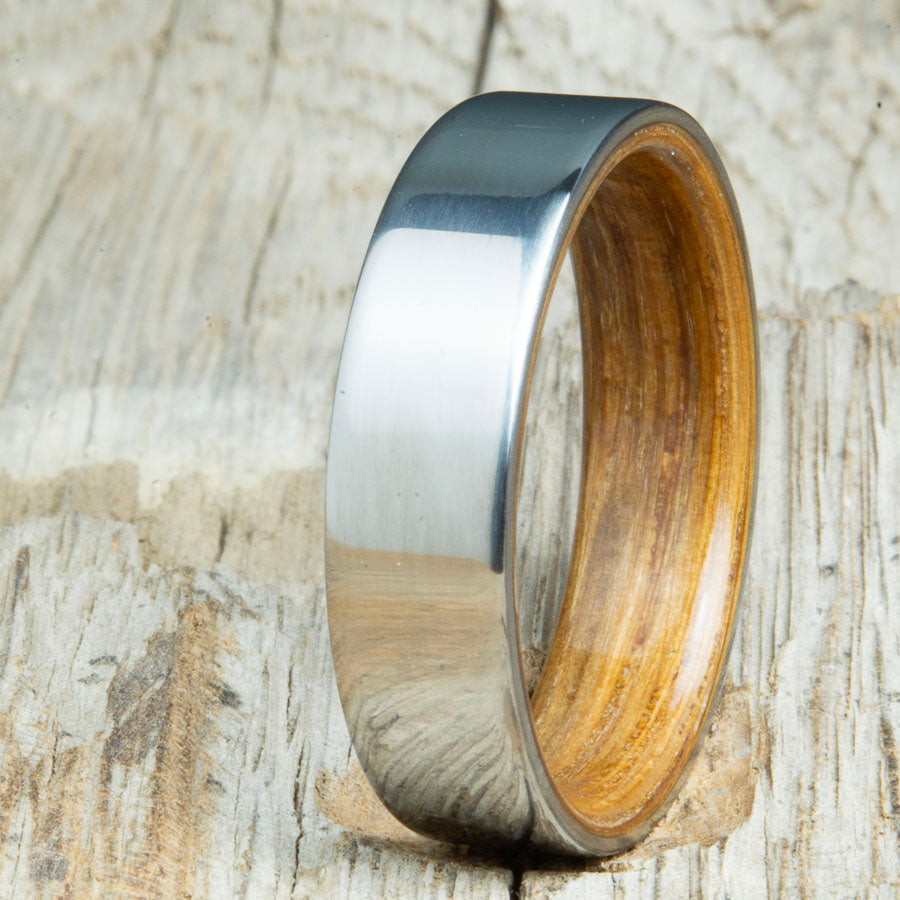 classic ring with whiskey barrel wood interior. Custom whiskey barrel wedding bands made by Peacefield Titanium