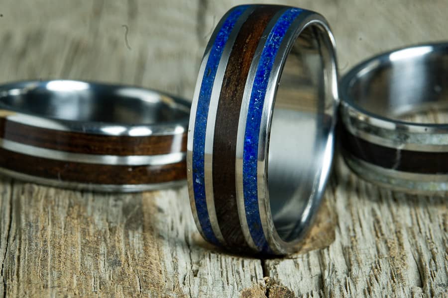 collection of ebony wood titanium rings made by peacefield titanium
