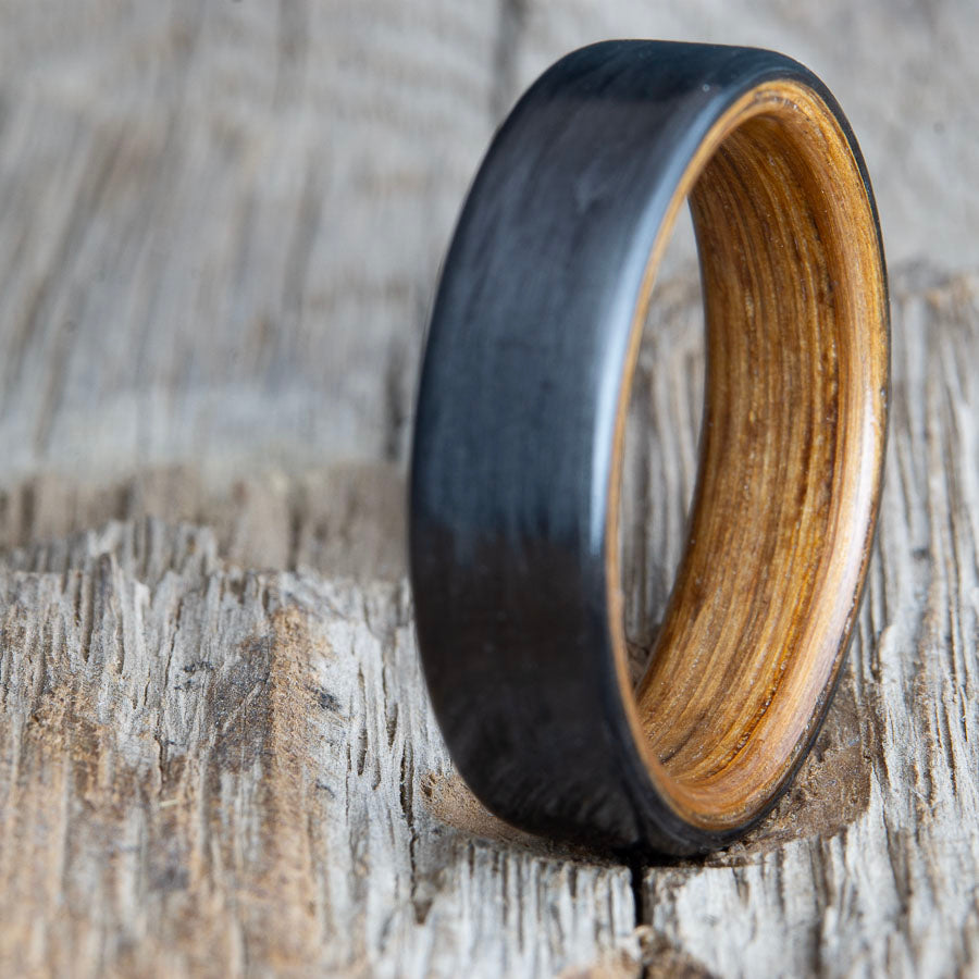black ring with carbon fiber and whiskey barrel wood