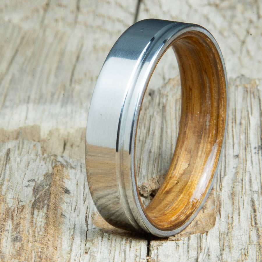 bentwood Jack Daniels whiskey barrel wood ring with polished titanium and single offset groove. Unique bentwood wedding bands made by Peacefield Titanium.