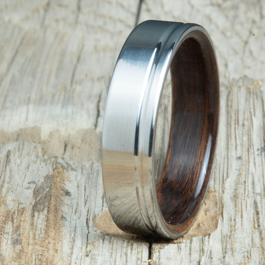bentwood Rosewood ring with polished titanium and single offset groove. Unique bentwood wedding bands made by Peacefield Titanium.