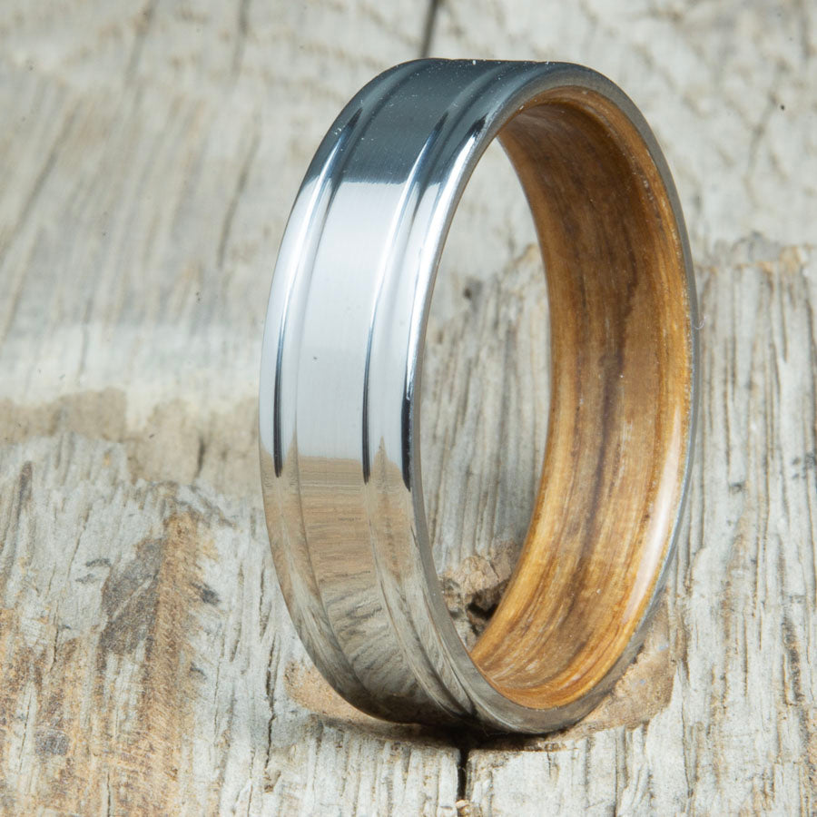 Jack Daniels whiskey barrel bentwood ring with polished double groove 6mm titanium. Custom bentwood wedding bands made by Peacefield Titanium