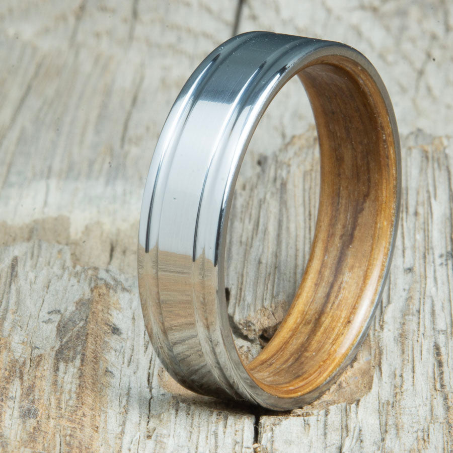 Jack Daniels whiskey barrel bentwood ring with polished double groove 6mm titanium. Custom bentwood wedding bands made by Peacefield Titanium