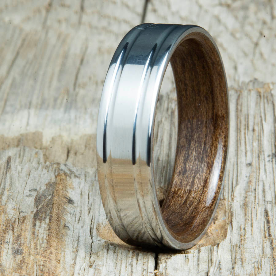 Walnut bentwood ring with polished double groove 6mm titanium. Custom bentwood wedding bands made by Peacefield Titanium