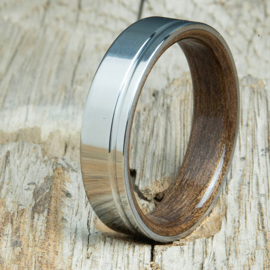 bentwood walnut ring with polished titanium and single offset groove. Unique bentwood wedding bands made by Peacefield Titanium.
