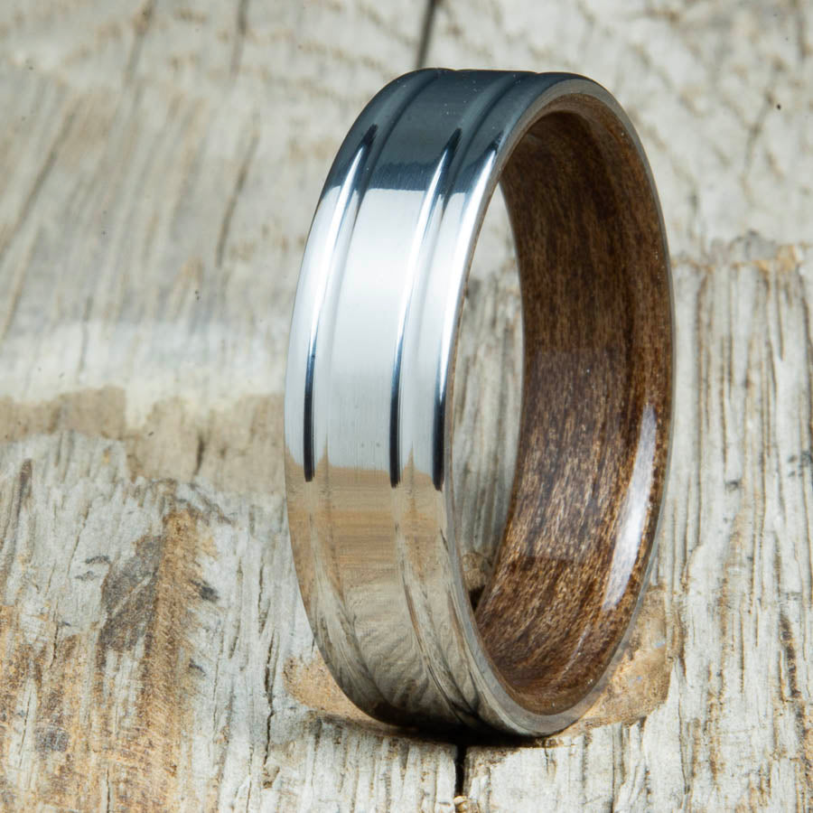 Walnut bentwood ring with polished double groove 6mm titanium. Custom bentwood wedding bands made by Peacefield Titanium