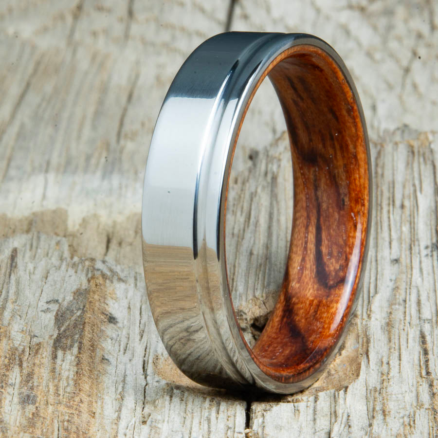 bentwood Bubinga ring with polished titanium and single offset groove. Unique bentwood wedding bands made by Peacefield Titanium.