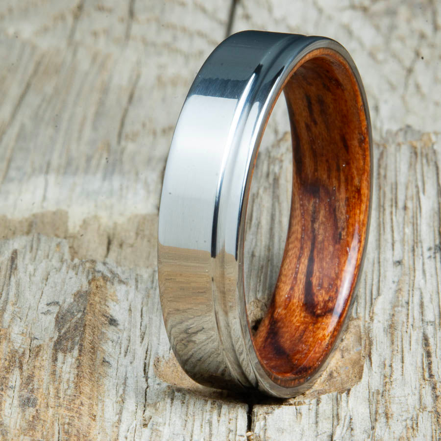 bentwood Bubinga ring with polished titanium and single offset groove. Unique bentwood wedding bands made by Peacefield Titanium.
