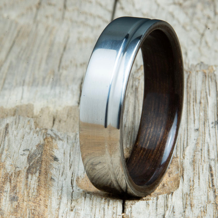 bentwood Ebony ring with polished titanium and single offset groove. Unique bentwood wedding bands made by Peacefield Titanium.