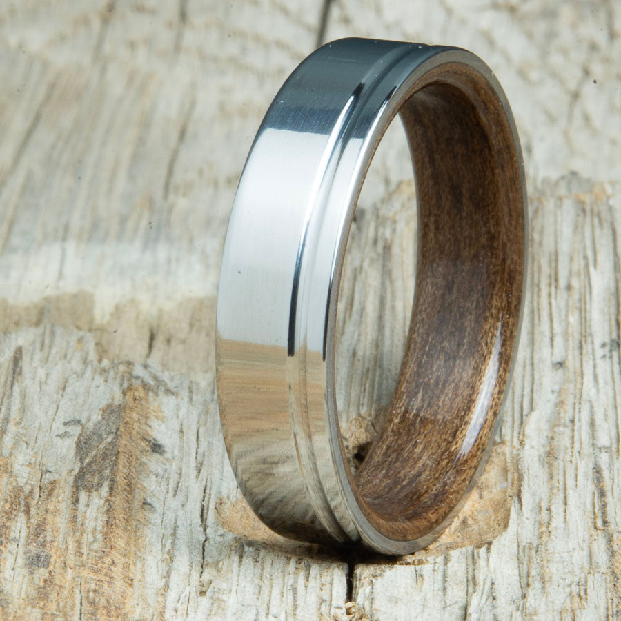 bentwood walnut ring with polished titanium and single offset groove. Unique bentwood wedding bands made by Peacefield Titanium.