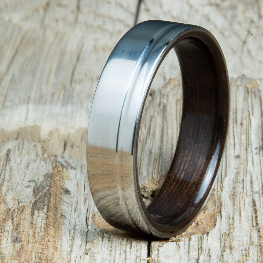 bentwood Ebony ring with polished titanium and single offset groove. Unique bentwood wedding bands made by Peacefield Titanium.