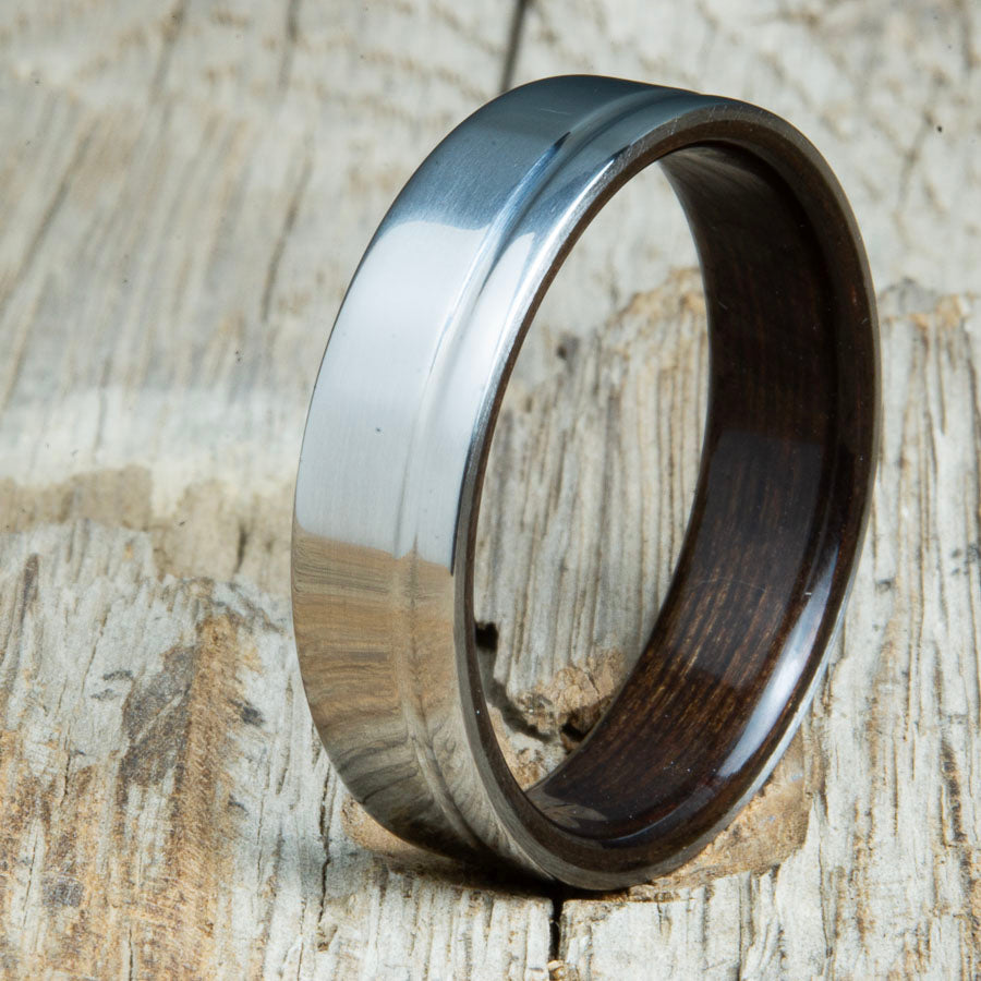 bentwood Ebony ring with polished titanium and single offset groove. Unique bentwood wedding bands made by Peacefield Titanium.