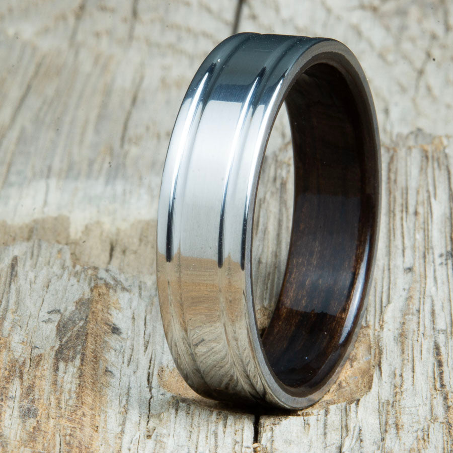 Ebony bentwood ring with polished double groove 6mm titanium. Custom bentwood wedding bands made by Peacefield Titanium