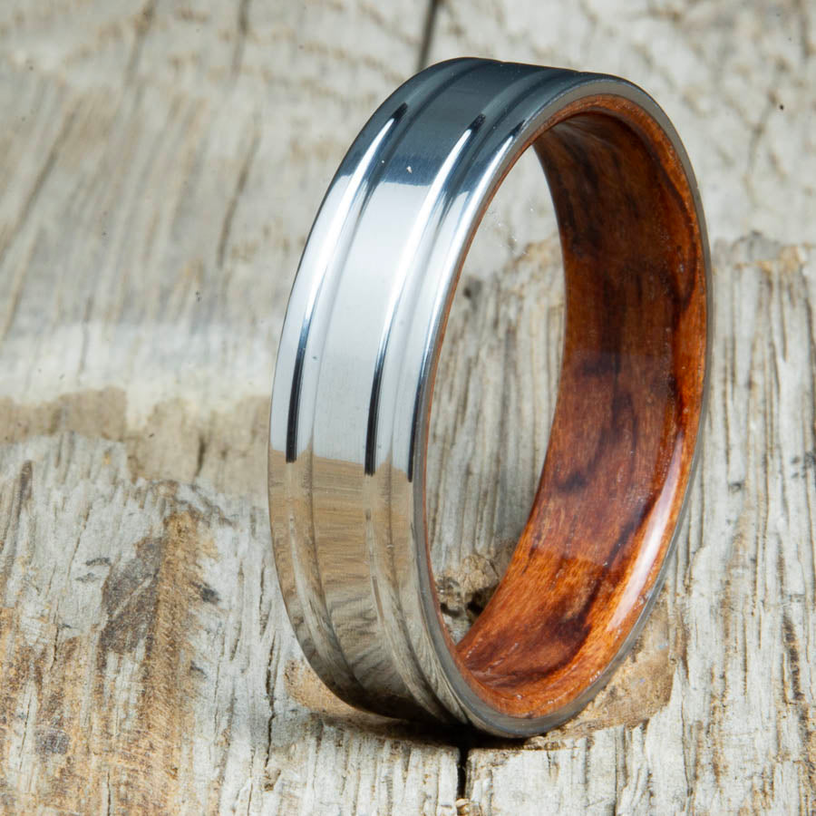 Bubinga bentwood ring with polished double groove 6mm titanium. Custom bentwood wedding bands made by Peacefield Titanium