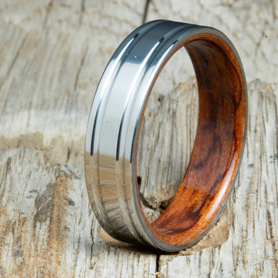 Bubinga bentwood ring with polished double groove 6mm titanium. Custom bentwood wedding bands made by Peacefield Titanium