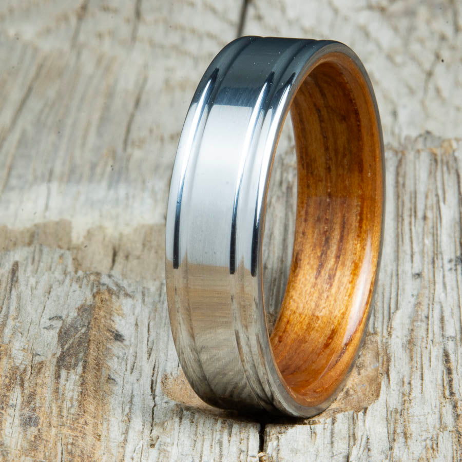 Koa bentwood ring with polished double groove 6mm titanium. Custom bentwood wedding bands made by Peacefield Titanium