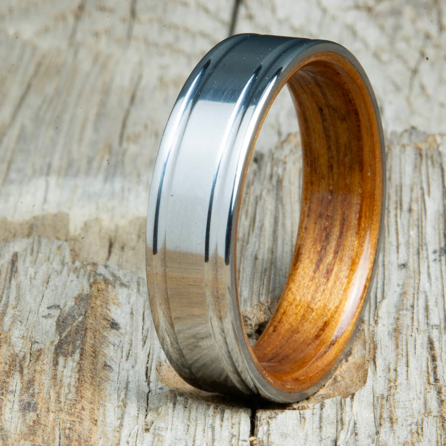 Koa bentwood ring with polished double groove 6mm titanium. Custom bentwood wedding bands made by Peacefield Titanium