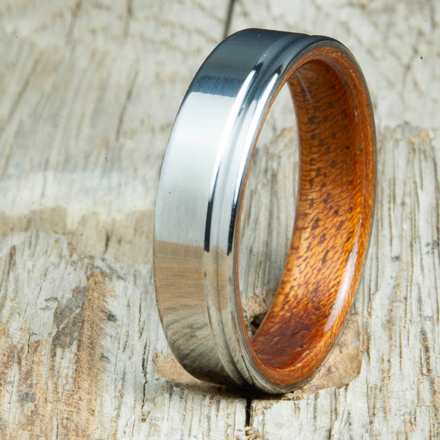 bentwood Acacia ring with polished titanium and single offset groove. Unique bentwood wedding bands made by Peacefield Titanium.
