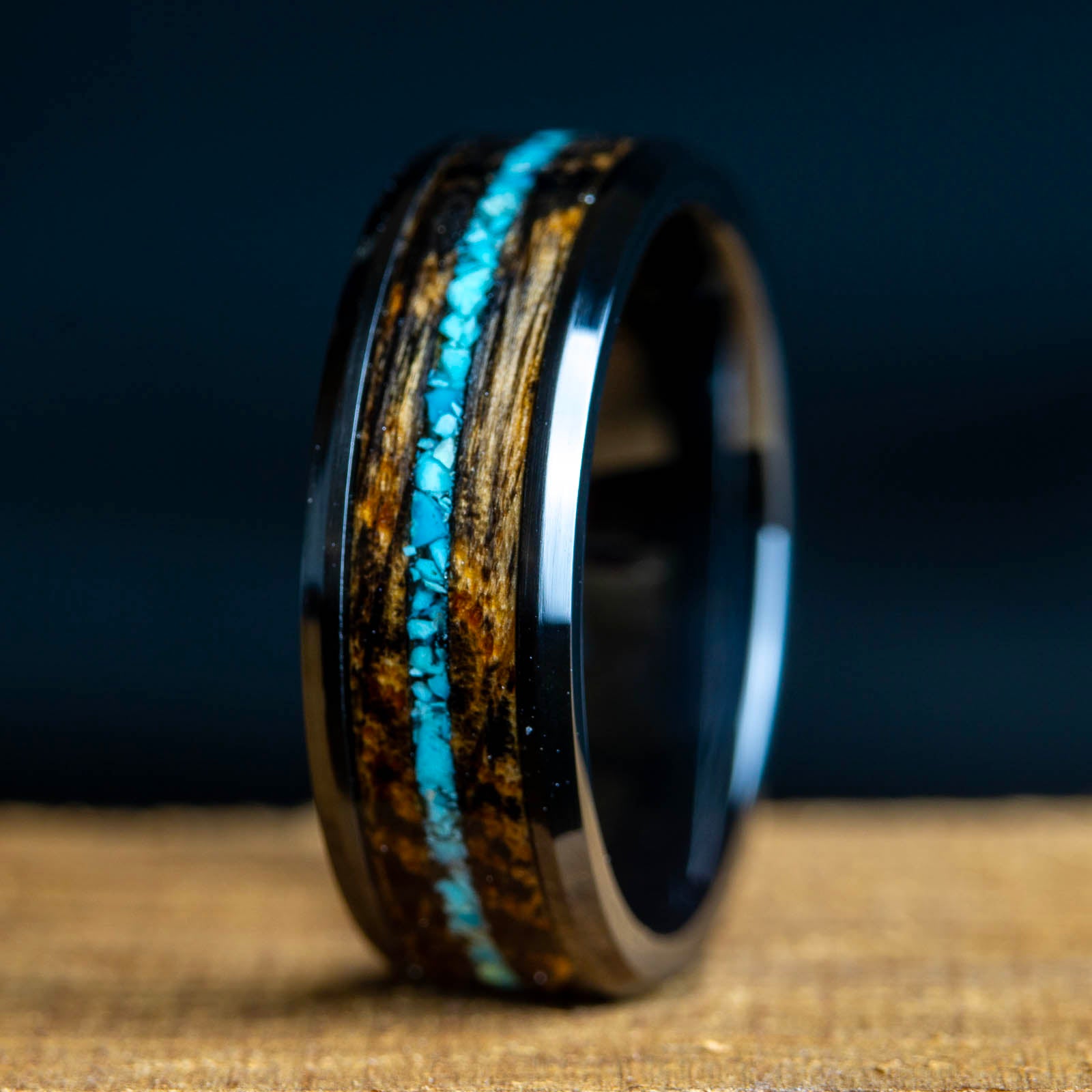 Wooden ring with a blue inlay on a dark background
