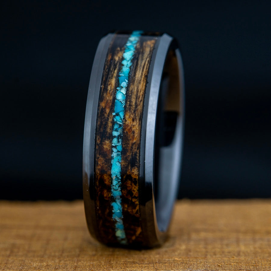 Black ring with whiskey barrel wood and turquoise inlay