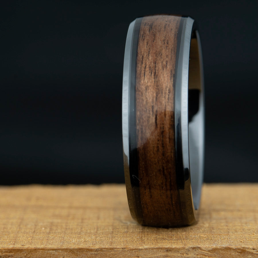 Wooden ring with a dark brown finish on a wooden surface