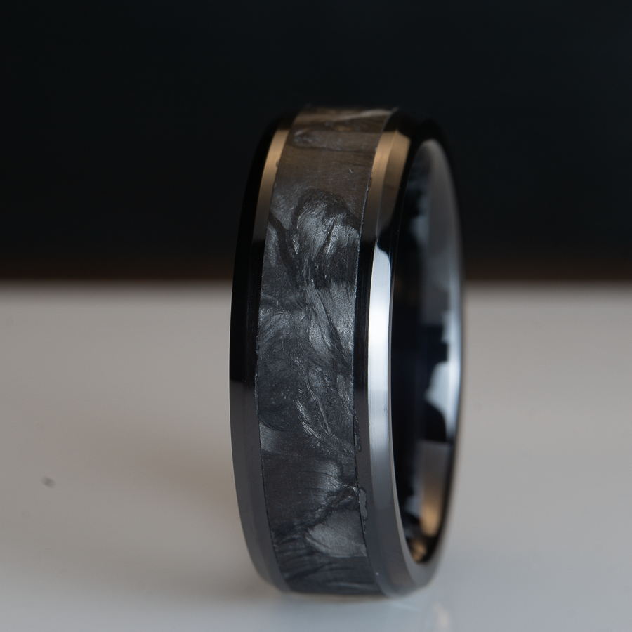 forged carbon fiber ring on black ceramic