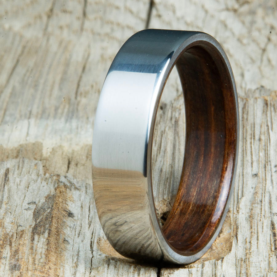 Classic mens Ebony wood wedding band with polished titanium. Custom wood rings made by Peacefield Titanium
