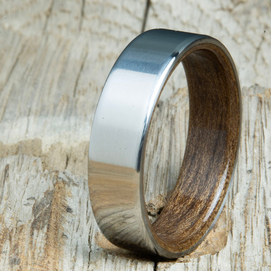 Classic mens Walnut wood wedding band with polished titanium. Custom wood rings made by Peacefield Titanium