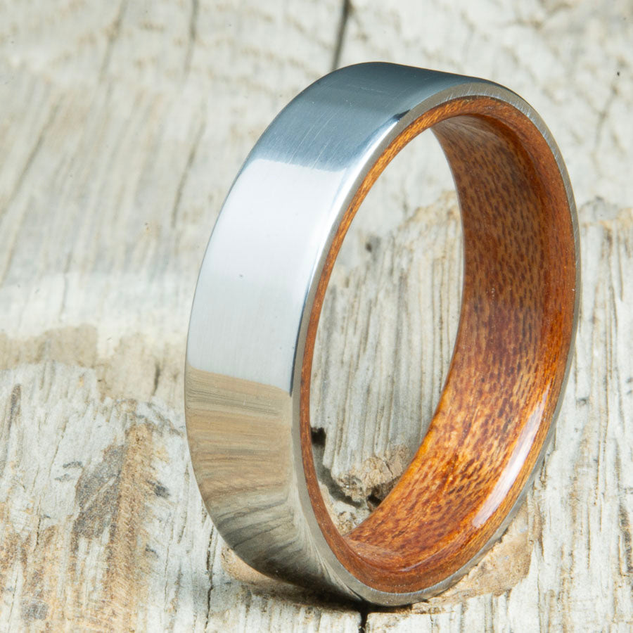 Classic mens Acacia wood wedding band with polished titanium. Custom wood rings made by Peacefield Titanium