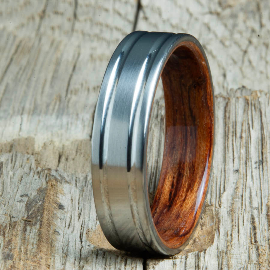 Double groove satin titanium wood ring with Bubinga wood interior. Unique handcrafted wedding rings made by Peacefield Titanium