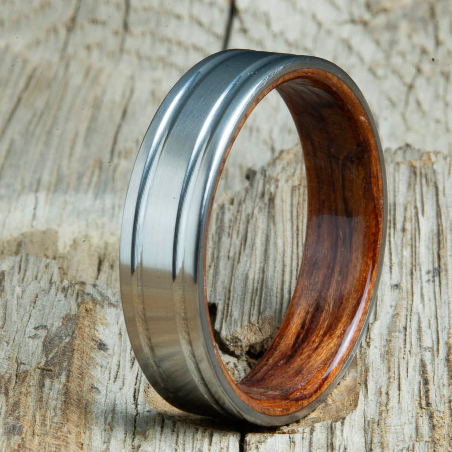 Double groove satin titanium wood ring with Bubinga wood interior. Unique handcrafted wedding rings made by Peacefield Titanium