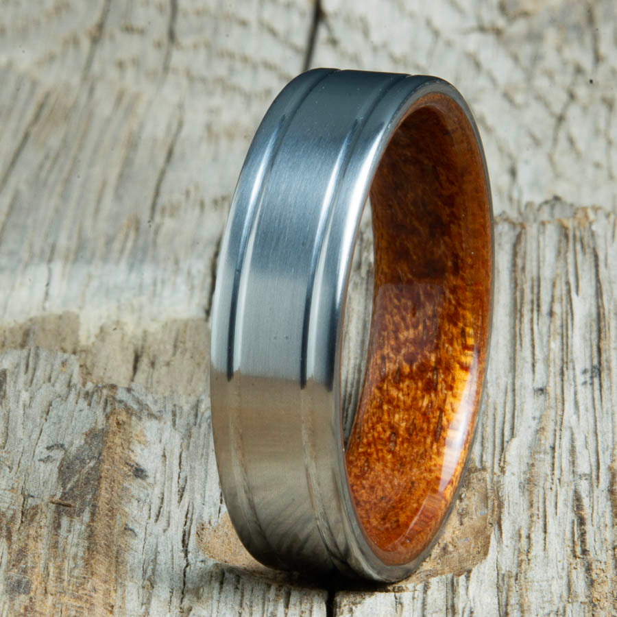 Double groove satin titanium wood ring with Acacia wood interior. Unique handcrafted wedding rings made by Peacefield Titanium