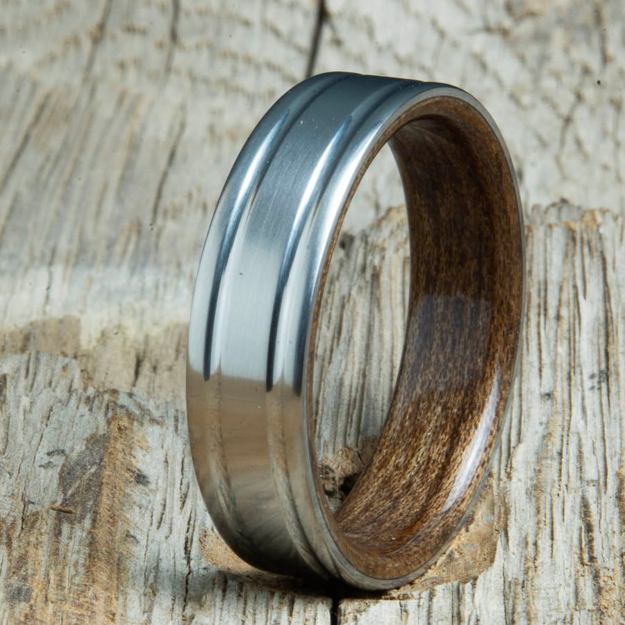 Double groove satin titanium wood ring with Walnut wood interior. Unique handcrafted wedding rings made by Peacefield Titanium