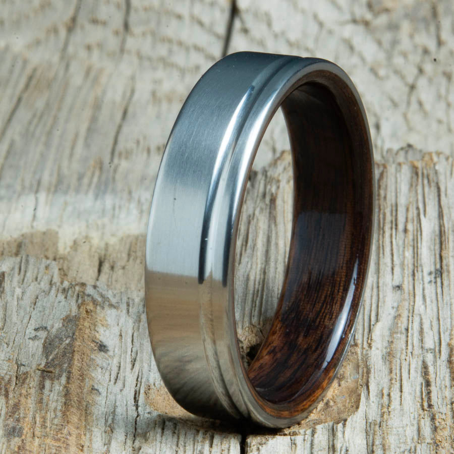 Single groove satin titanium wood ring with Ebony wood interior. Custom titanium wood rings handcrafted by Peacefield Titanium