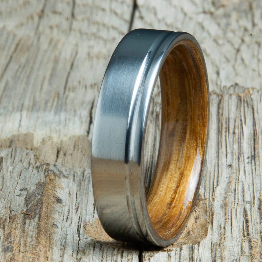 Single grooved pinstripe satin titanium mens ring with Whiskey barrel wood. Unique mens rings with wood and titanium made by Peacefield Titanium.