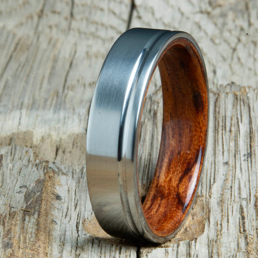 Single groove satin titanium wood ring with Bubinga wood interior. Custom titanium wood rings handcrafted by Peacefield Titanium