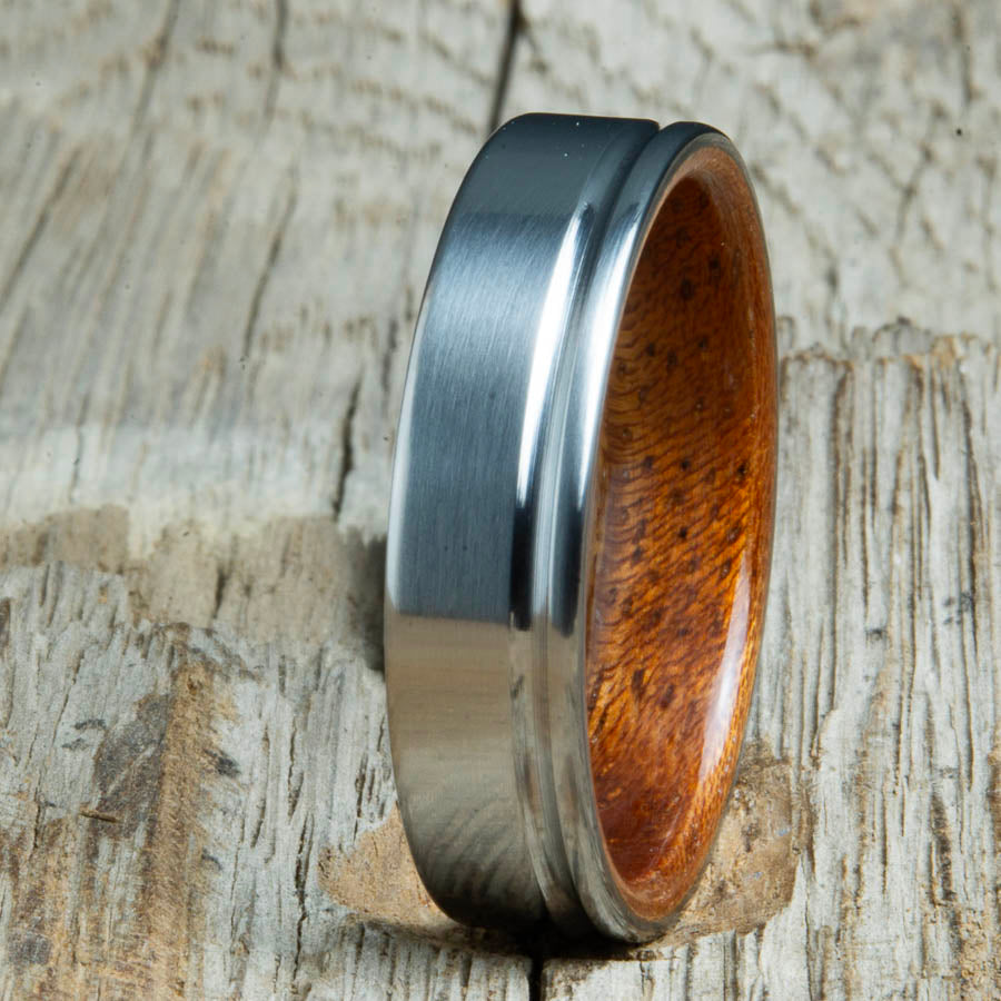 Single groove satin titanium wood ring with Acacai wood interior. Custom titanium wood rings handcrafted by Peacefield Titanium