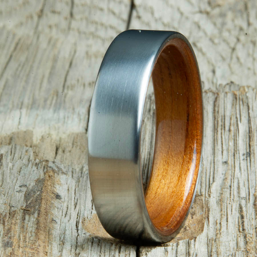 Mens rings with satin titanium and Hawaiian Koa wood interior. Unique Mens rings and wedding bands handcrafted by Peacefield Titanium