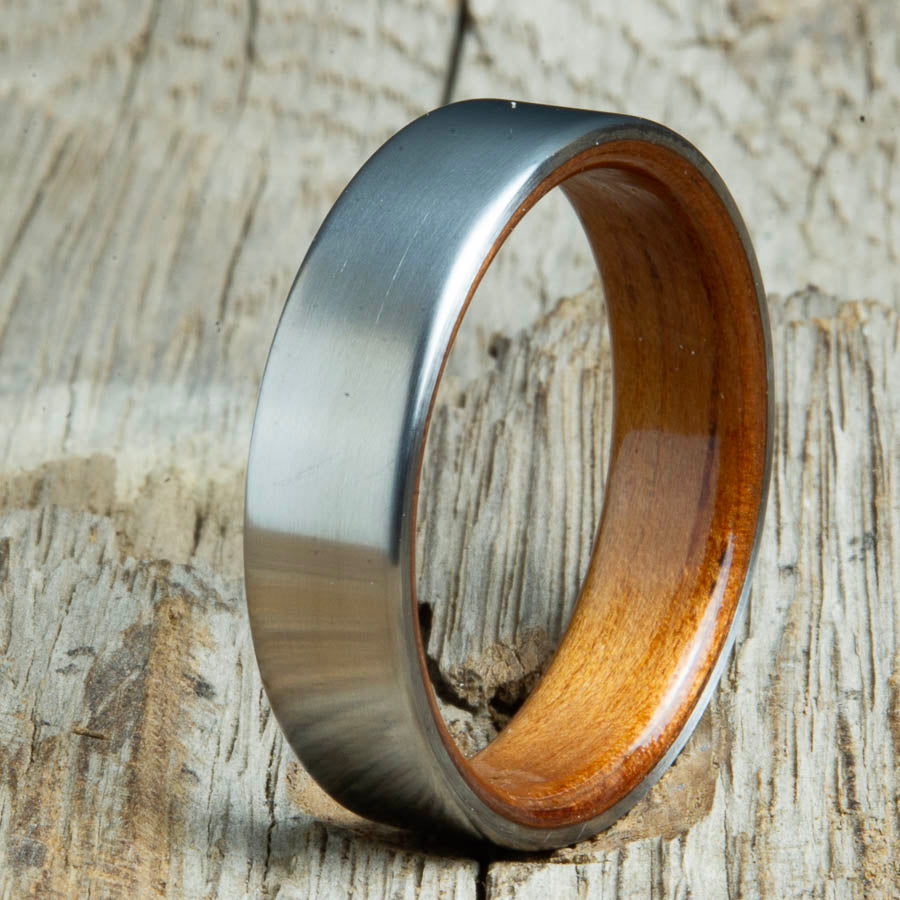 Mens rings with satin titanium and Hawaiian Koa wood interior. Unique Mens rings and wedding bands handcrafted by Peacefield Titanium