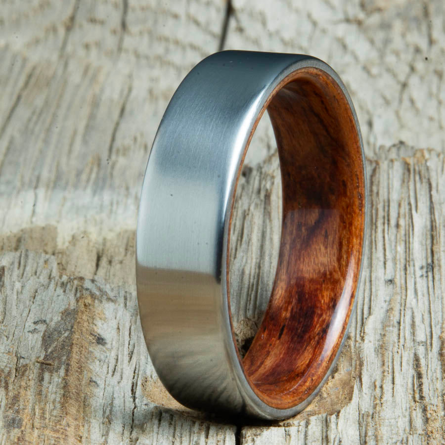 Mens rings with satin titanium and Bubinga wood interior. Unique Mens rings and wedding bands handcrafted by Peacefield Titanium