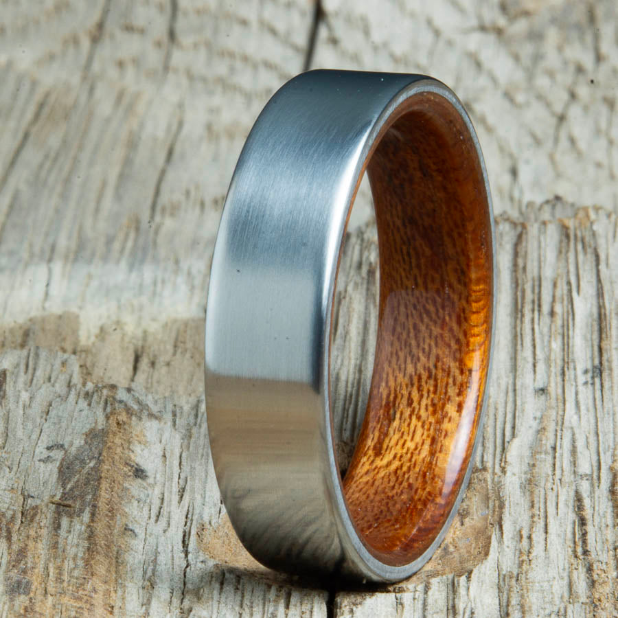 Mens rings with satin titanium and Acacia wood interior. Unique Mens rings and wedding bands handcrafted by Peacefield Titanium