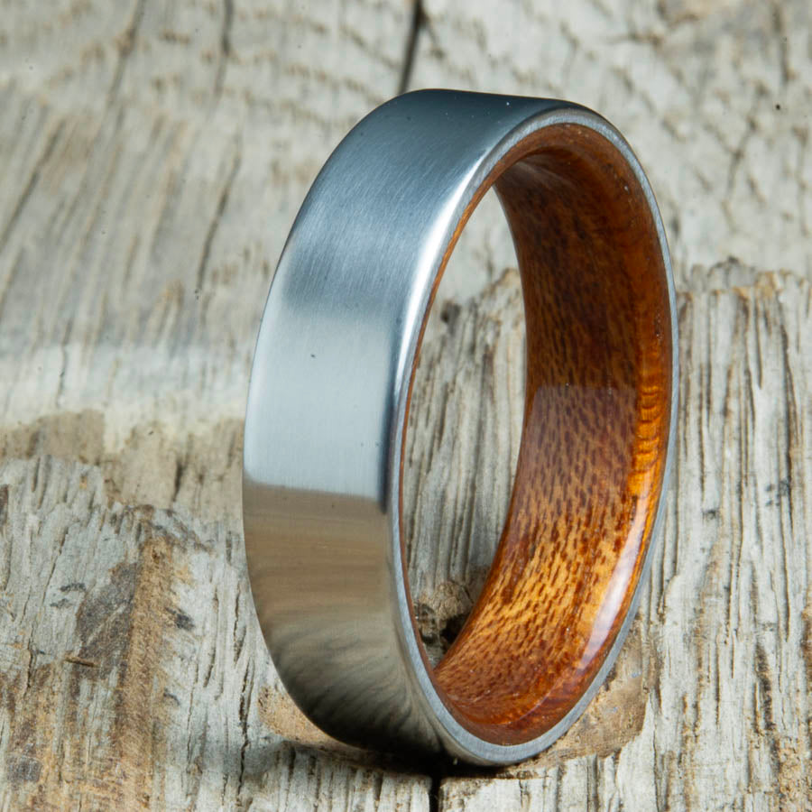 Mens rings with satin titanium and Acacia wood interior. Unique Mens rings and wedding bands handcrafted by Peacefield Titanium