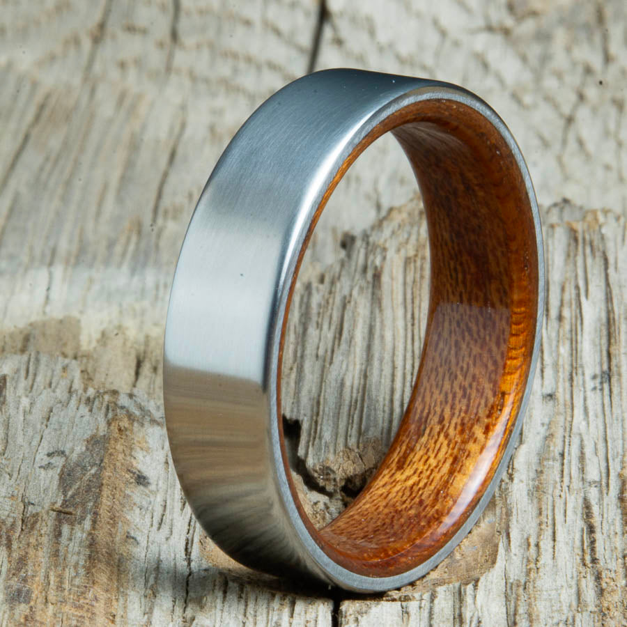 Mens rings with satin titanium and Acacia wood interior. Unique Mens rings and wedding bands handcrafted by Peacefield Titanium
