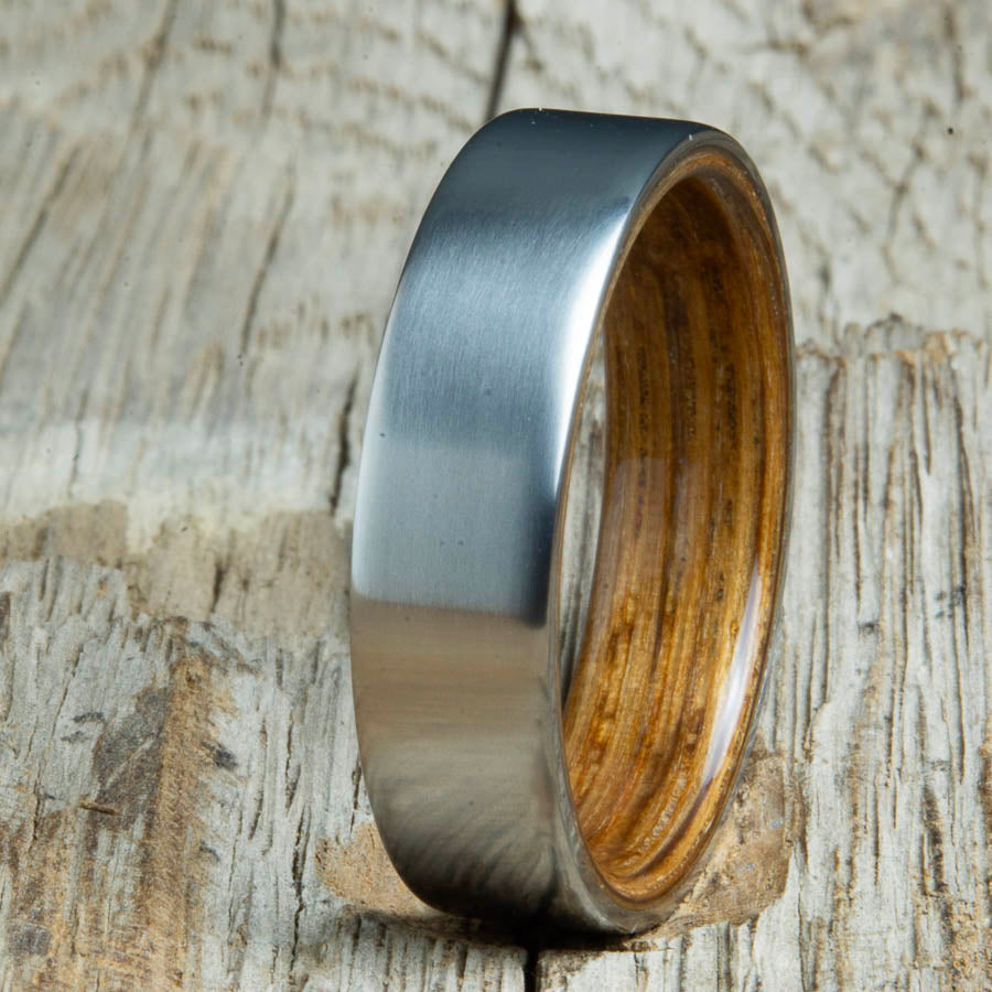 Mens rings with satin titanium and Whiskey barrel wood interior. Unique Mens rings and wedding bands handcrafted by Peacefield Titanium