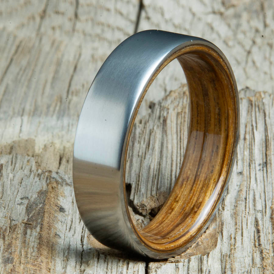 Mens rings with satin titanium and Whiskey barrel wood interior. Unique Mens rings and wedding bands handcrafted by Peacefield Titanium