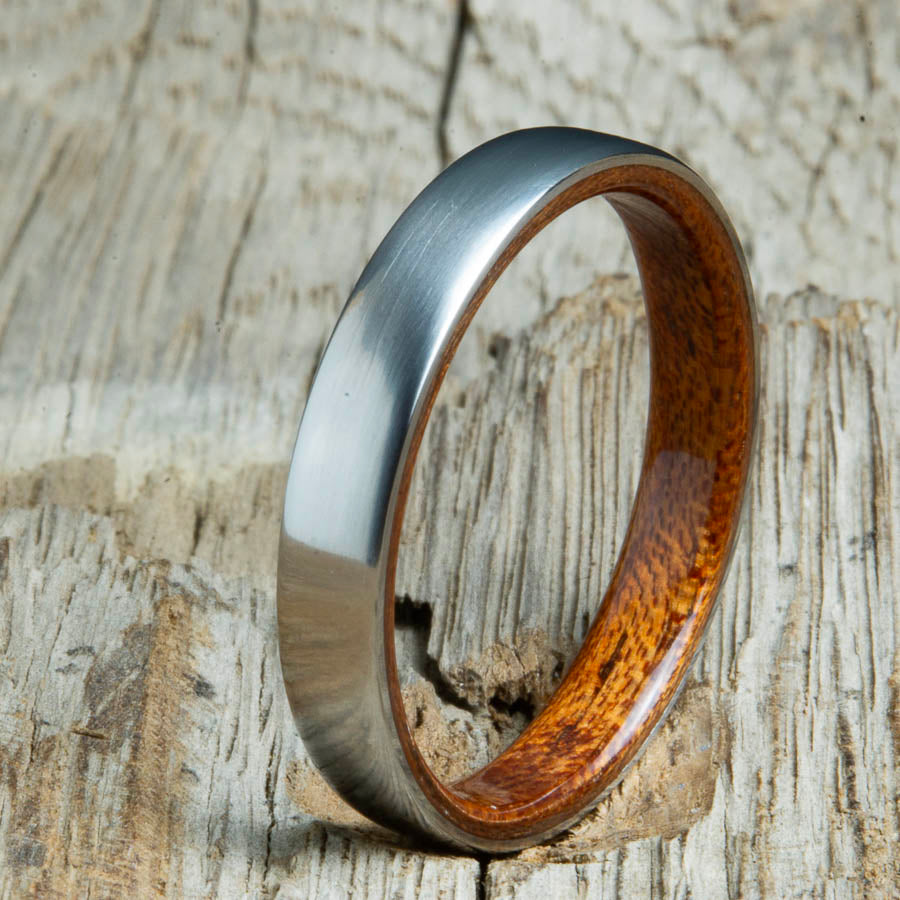 Acacia lined womens wood ring with satin titanium. Custom handcrafted womens wooden rings are made by Peacefield Titanium