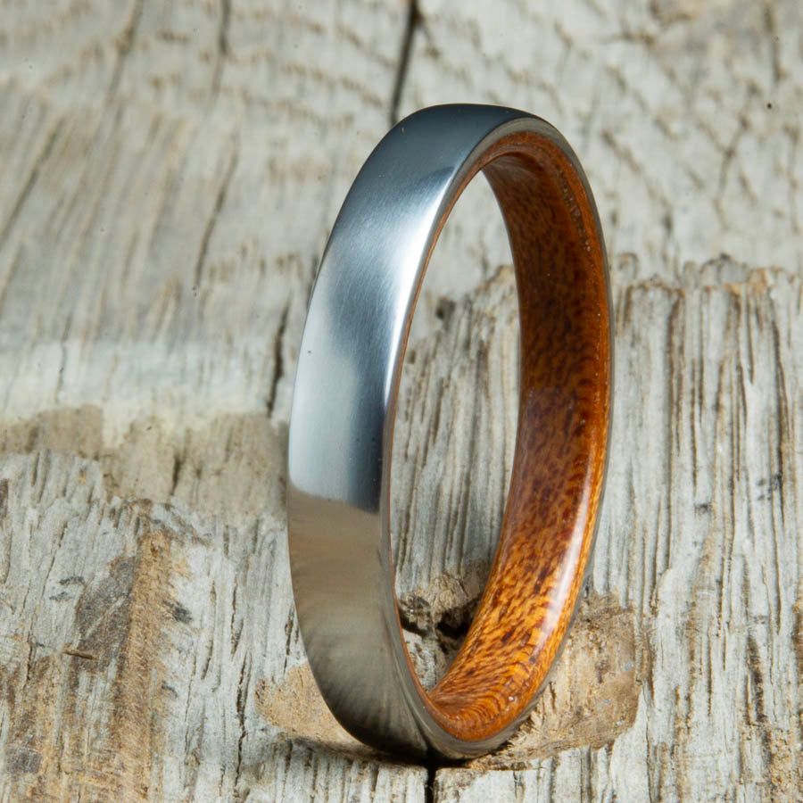 Acacia lined womens wood ring with satin titanium. Custom handcrafted womens wooden rings are made by Peacefield Titanium